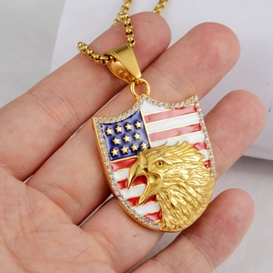 Close-up of golden eagle shield pendant with American flag pattern and crystal border