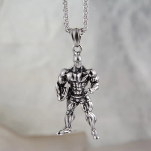 Détail macro du pendentif homme musclé au fini argent antique avec chaîne épi