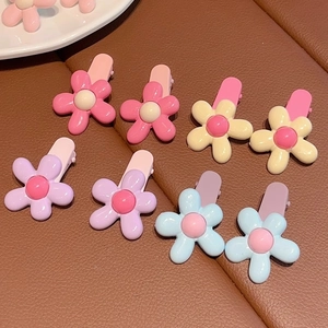 Set of four candy-colored flower hair clips in pink, yellow, purple and blue for girls