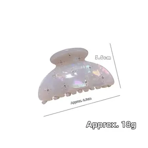 Detail view of pearlescent acetate hair claw with rhinestones, size 6.5cm x 3.5cm