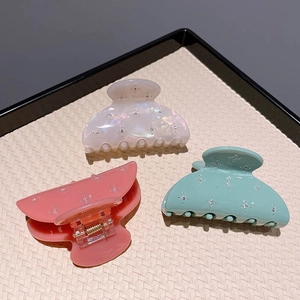Three elegant French style acetate hair claws in white, pink and green with rhinestones