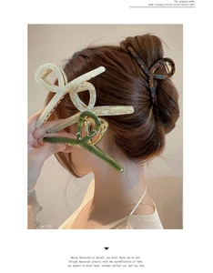Detail of large acetate hair claw clip showing tortoise shell and cream textures