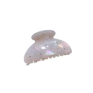 French luxury acetate hair claw in iridescent pearl white with sparkling star pattern