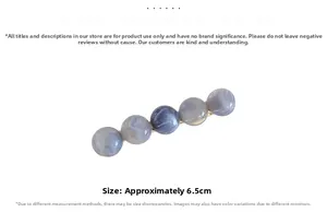 Detail view of a 6.5cm hair clip with blue and purple marble texture resin beads