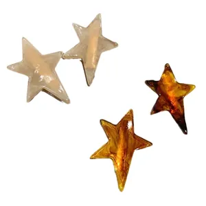 Star-shaped acetate hair clips in creamy white marble and dark tortoiseshell patterns