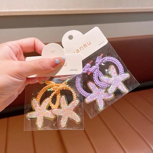 Cute glittery star hair clips in purple and orange for girls' hair styling