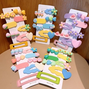Detail showing macaron color resin hair clips in flower and heart shapes on display cards