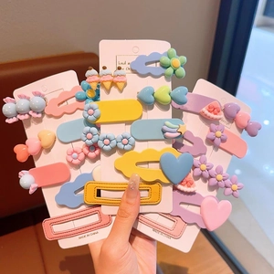 Colorful candy hair clip set featuring flowers and hearts for girls on a white card display