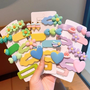 Close-up of colorful resin hair clips featuring flower, heart, and rainbow patterns