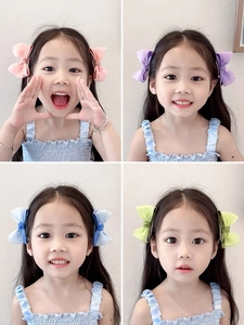 Detail shots of girls' fabric bow hair clips in four soft macaron pastel colors
