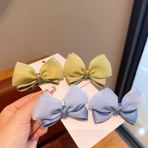 Set of four sweet fabric bow hair clips for girls in lime green and misty blue colors