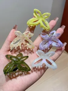 Detail of five colorful acetate butterfly hair claws with elegant marble patterns