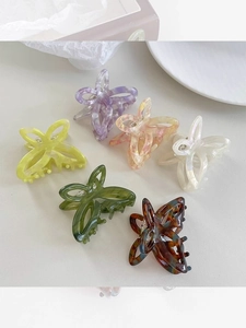 Detailed close-up showing six assorted colors of acetate butterfly hair claw clips