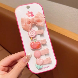 Detail van een 5-delige roze stoffen haarspeldjes set voor kinderen op kaartje