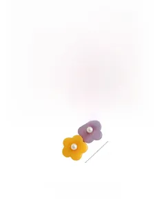 Détail de barrettes à cheveux en résine en forme de fleur avec perles en jaune et violet