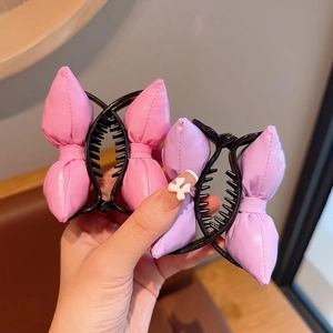 Set of two puffy bow banana hair clips in pink and purple shiny PU leather for girls