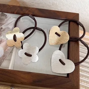 Set of 4 brushed metal heart and flower hair ties in gold and silver finish