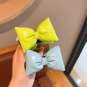 Stereo puffy bow hair clip in vibrant green and blue colors for girls' styling