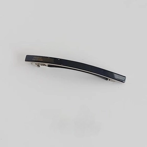 Detail view of handmade black acetate hair barrette with France Handmade silver lettering