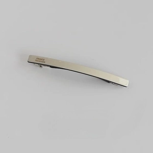 Close-up of ivory acetate barrette showing the silver metal base and handmade engraving