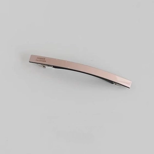 Macro view of rose gold acetate spring hair clip with France Handmade engraving detail