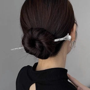 Vintage silver metal flower hair pin with pearl accent for elegant bun hairstyles