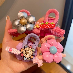 Detail view of colorful floral hair clips and strawberry claw clip set for girls