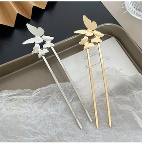 Detailed view of elegant gold and silver butterfly hairpins for traditional styling