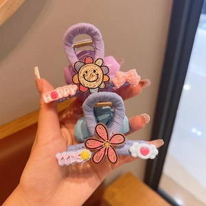 Cute knitted flower hair claw clips for girls featuring smiling sun and happy letters