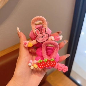 Detail shot of pink floral hair clips featuring Lucky hearts and cartoon charms