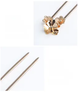 Close-up of golden metal hair stick featuring elegant double-tooth fork and floral details