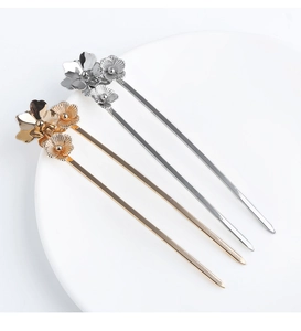 Detail of elegant gold and silver metal flower hairpins for classic Chinese hairstyling
