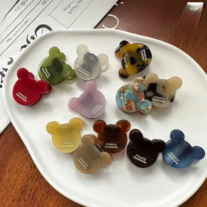 Close-up of colorful bear-shaped acetate hair claws with France Handmade gold text