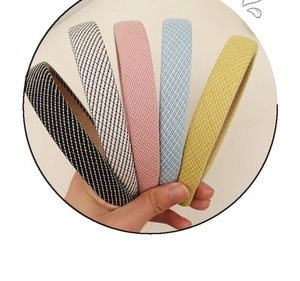 Close-up of five colorful knitted sponge headbands in various patterns and textures