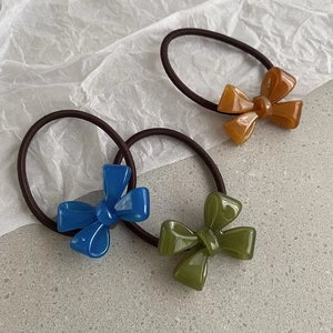 Three-piece set of elegant bow hair ties in blue, olive green and amber brown