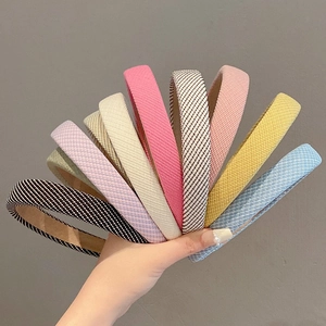 Detailed set of colorful sponge headbands in striped, solid, and plaid woven fabric