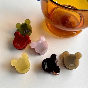 Set of bear-shaped acetate hair claws in various colors with handmade gold lettering