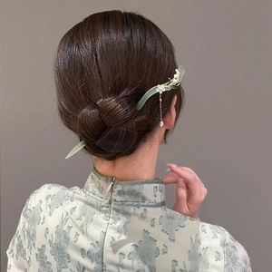Detail of vintage lily of the valley hair pin with pearl tassel on hair