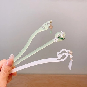 Detailed view of Chinese hair sticks with lily of the valley and cloud tassels