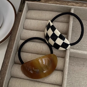 Chic acetate hair ties set featuring checkerboard and amber patterns for stylish ponytails