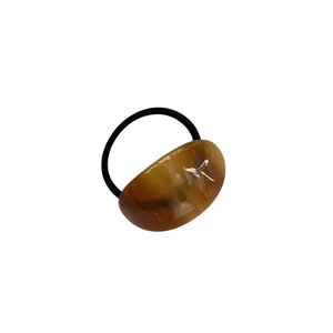 Minimalist tortoiseshell acetate oval hair tie with elastic black rope on white background