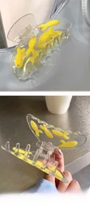 Detail showing blue acetate hair claw clip with yellow rhinestone fish decoration
