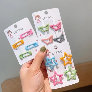 Close-up of star and butterfly shaped candy-colored hair clips in matte finish for girls