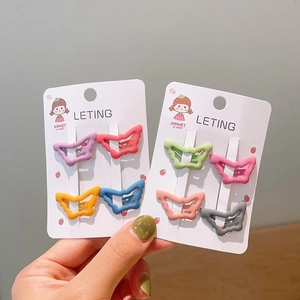 Close-up of eight colorful butterfly hollow hair clips set on a cute cartoon display card