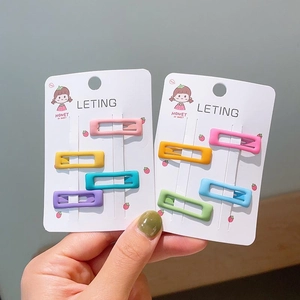 Close-up of colorful matte macaron square snap hair clips on branded display card