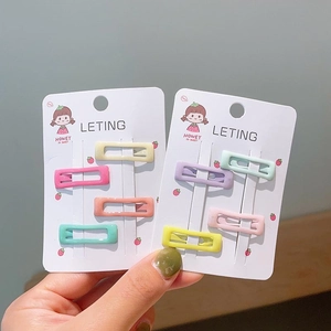 Close-up of colorful rectangle BB hair clips in pastel candy colors on card
