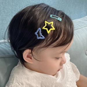 Child star hair clips set with blue butterfly and yellow star shapes on a toddler girl
