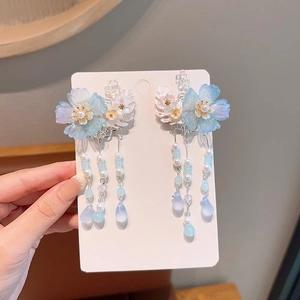 Close-up of blue floral hair clips with tassels and pearls for girls' Hanfu costume