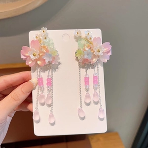 Close-up of Hanfu hair clips featuring pink resin flowers and silver tassel chains with beads