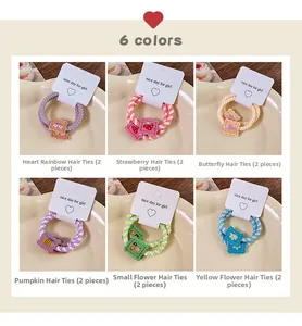 Detail view of 6 colorful woven hair ties sets with resin biscuit and flower shapes